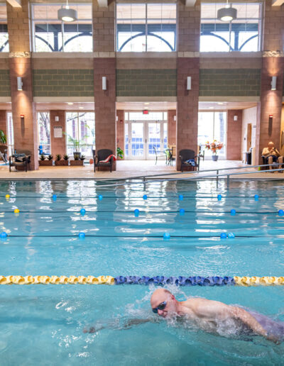 Man swims in lap pool.