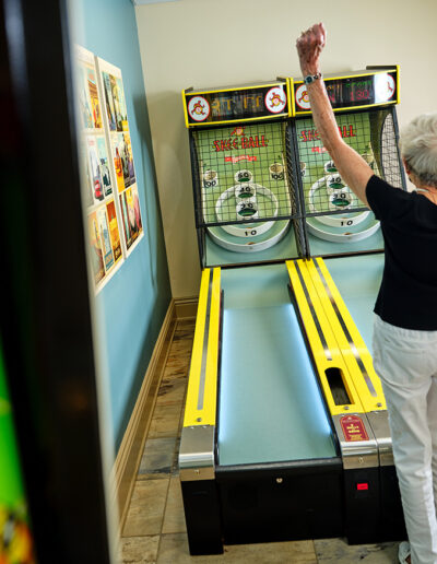 Woman enjoys the Skee Ball games at her Quarryville community.
